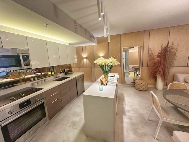 1010 SW 2nd Ave Unit 601, Miami, FL 33130 - kitchen with stainless steel appliances, light countertops, modern cabinets, and a center island