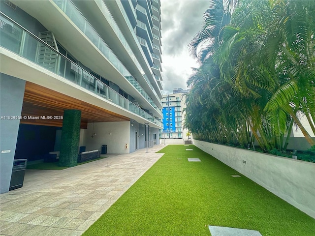 1010 SW 2nd Ave Unit 601, Miami, FL 33130 - view of community featuring a patio and a lawn