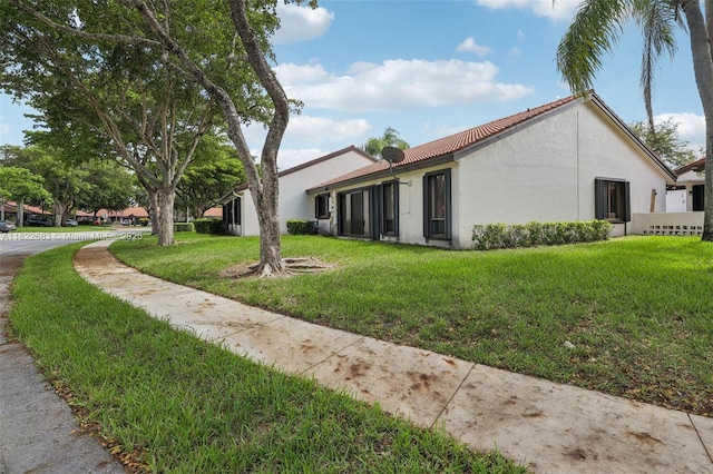 7121 Mimosa Way, Tamarac, FL 33321 - view of home's exterior featuring stucco siding and a lawn