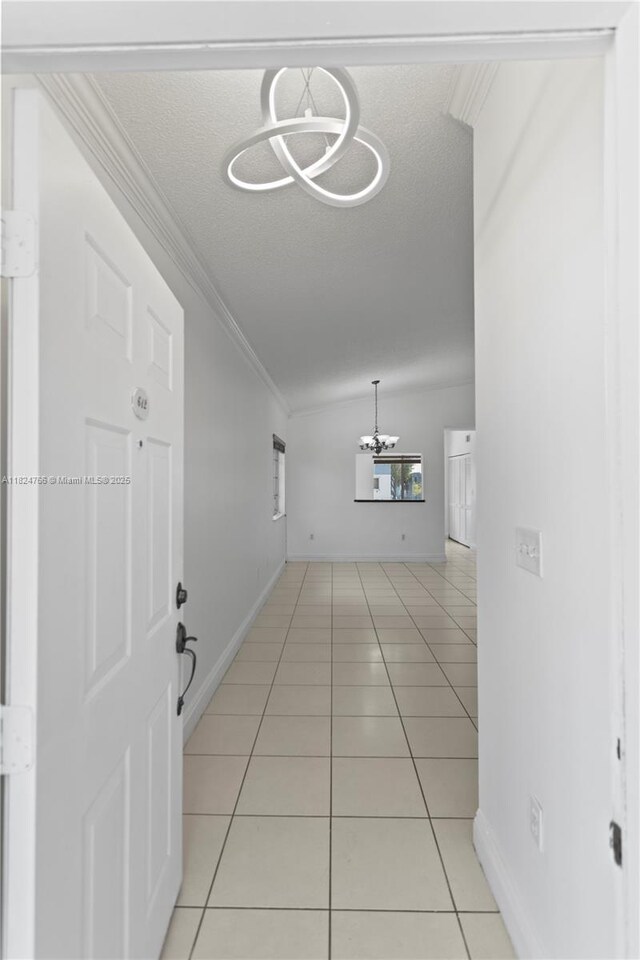 6445 SW 130th Pl Unit 612, Miami, FL 33183 - corridor with a chandelier, light tile patterned floors, a textured ceiling, and crown molding