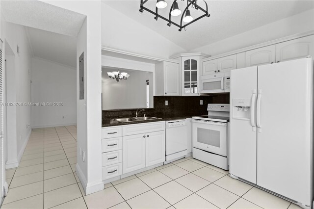 6445 SW 130th Pl Unit 612, Miami, FL 33183 - kitchen with white appliances, a chandelier, dark countertops, light tile patterned flooring, and glass insert cabinets