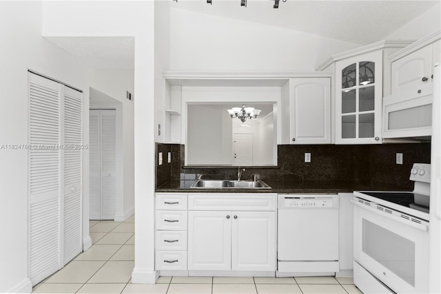 6445 SW 130th Pl Unit 612, Miami, FL 33183 - kitchen featuring white appliances, a chandelier, dark countertops, light tile patterned flooring, and tasteful backsplash