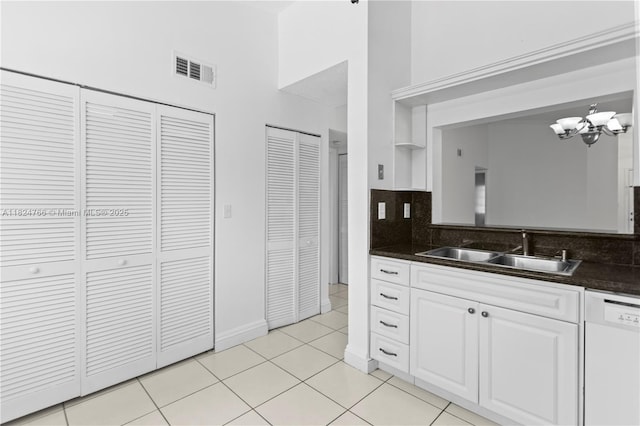 6445 SW 130th Pl Unit 612, Miami, FL 33183 - kitchen with dishwasher, dark countertops, a chandelier, white cabinetry, and backsplash