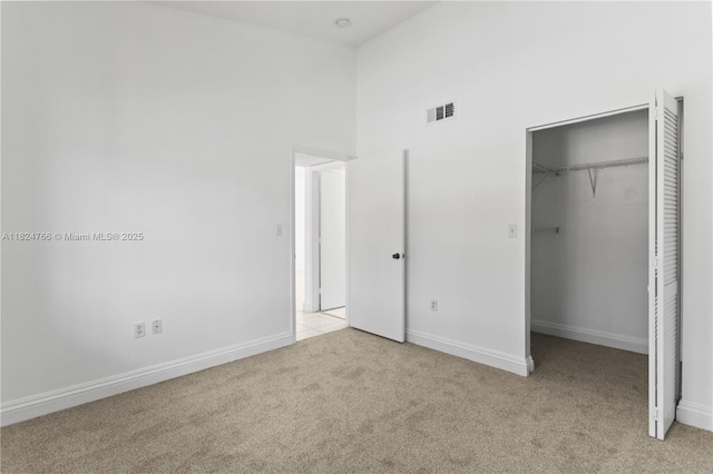 6445 SW 130th Pl Unit 612, Miami, FL 33183 - unfurnished bedroom featuring light colored carpet, a walk in closet, a high ceiling, and a closet