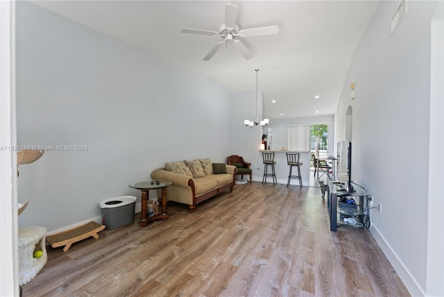 18739 SW 28th St, Miramar, FL 33029 - living room featuring wood finished floors, ceiling fan, arched walkways, and vaulted ceiling
