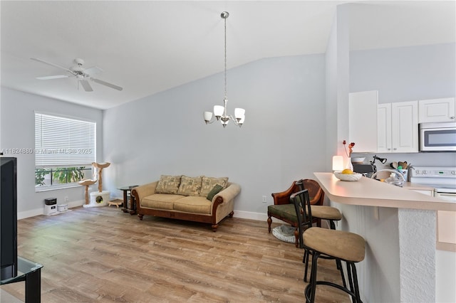 18739 SW 28th St, Miramar, FL 33029 - living area featuring lofted ceiling, light wood-style flooring, a chandelier, and a ceiling fan