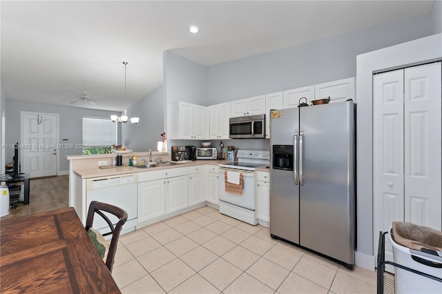 18739 SW 28th St, Miramar, FL 33029 - kitchen with appliances with stainless steel finishes, white cabinetry, a peninsula, light countertops, and a chandelier