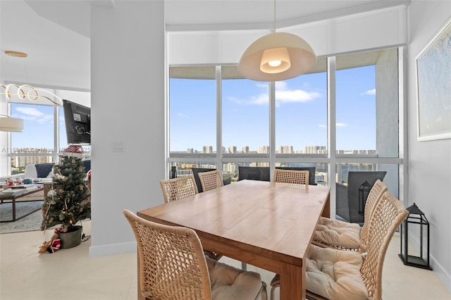 18201 Collins Ave Unit 201A, Sunny Isles Beach, FL 33160 - dining space featuring baseboards and a chandelier