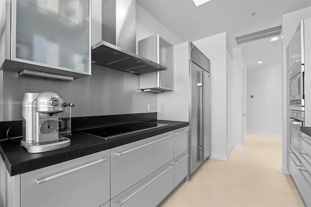 18201 Collins Ave Unit 201A, Sunny Isles Beach, FL 33160 - kitchen with wall chimney exhaust hood, modern cabinets, built in appliances, dark countertops, and white cabinetry