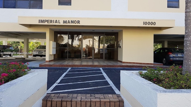 10000 Bay Harbor Ter Unit 502-A, Bay Harbor Islands, FL 33154 - view of exterior entry featuring uncovered parking and stucco siding