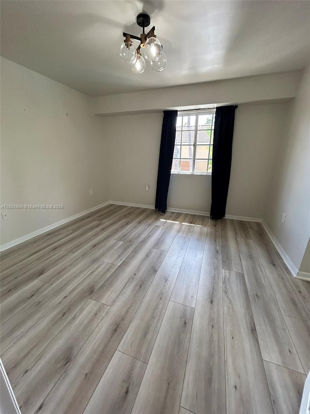 2921 NE 185th St Unit 1205, Aventura, FL 33180 - empty room featuring a chandelier and light wood finished floors