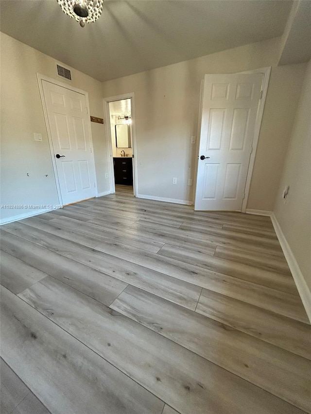 2921 NE 185th St Unit 1205, Aventura, FL 33180 - unfurnished bedroom featuring wood finished floors and ensuite bathroom