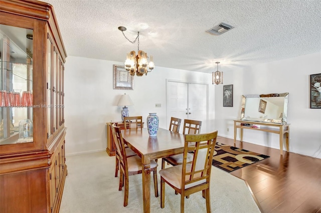 1600 SW 72nd Ave, Plantation, FL 33317 - dining room with a chandelier, a textured ceiling, and light colored carpet