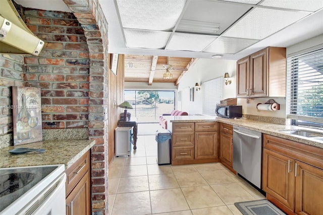 1600 SW 72nd Ave, Plantation, FL 33317 - kitchen with stainless steel dishwasher, range hood, black microwave, light stone counters, and light tile patterned flooring