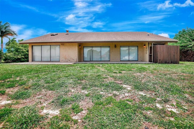 1600 SW 72nd Ave, Plantation, FL 33317 - rear view of property with stucco siding and a lawn