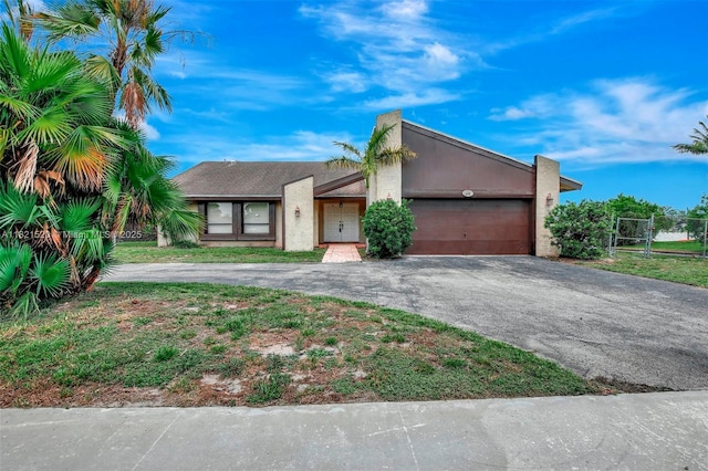 1600 SW 72nd Ave, Plantation, FL 33317 - view of front of property with driveway, a garage, and stucco siding
