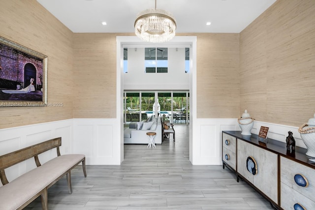 6790 SW 72nd Ct, Miami, FL 33143 - corridor with a chandelier, a wainscoted wall, recessed lighting, and a decorative wall