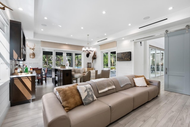 6790 SW 72nd Ct, Miami, FL 33143 - living room featuring a barn door, light wood-type flooring, recessed lighting, and a chandelier