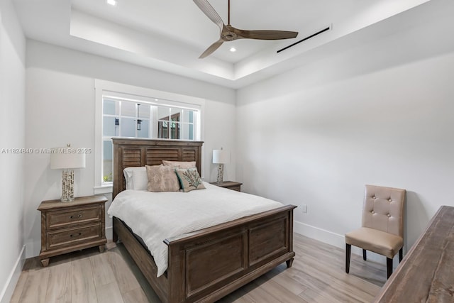 6790 SW 72nd Ct, Miami, FL 33143 - bedroom featuring a tray ceiling, light wood-type flooring, recessed lighting, and a ceiling fan