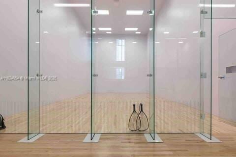 851 NE 1st Ave Unit 503, Miami, FL 33132 - bathroom with wood finished floors and a shower with door
