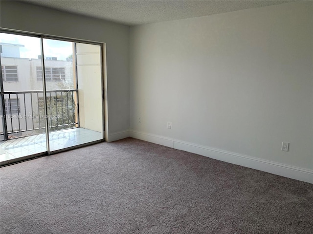 1250 NE 125th St Unit 410C, North Miami, FL 33161 - carpeted empty room with a textured ceiling and baseboards