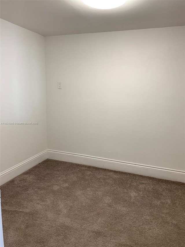 1250 NE 125th St Unit 410C, North Miami, FL 33161 - carpeted spare room featuring baseboards