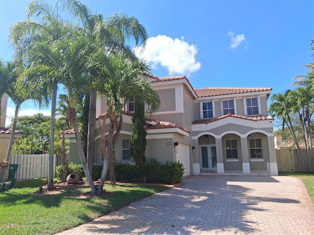3610 SW 167th Ter, Miramar, FL 33027 - mediterranean / spanish-style house with stucco siding, a tiled roof, decorative driveway, and a garage
