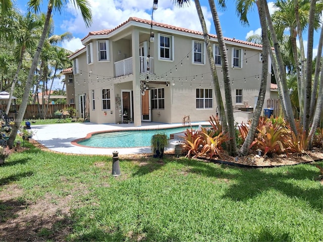 3610 SW 167th Ter, Miramar, FL 33027 - back of property with a balcony, a tile roof, stucco siding, and a patio area