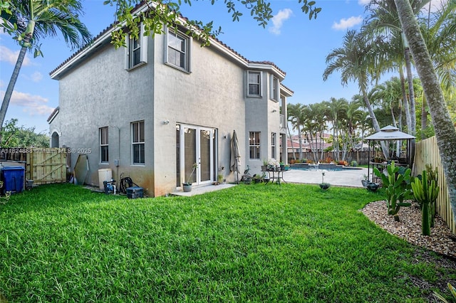 3610 SW 167th Ter, Miramar, FL 33027 - rear view of property with stucco siding, a fenced backyard, a gazebo, and a gate