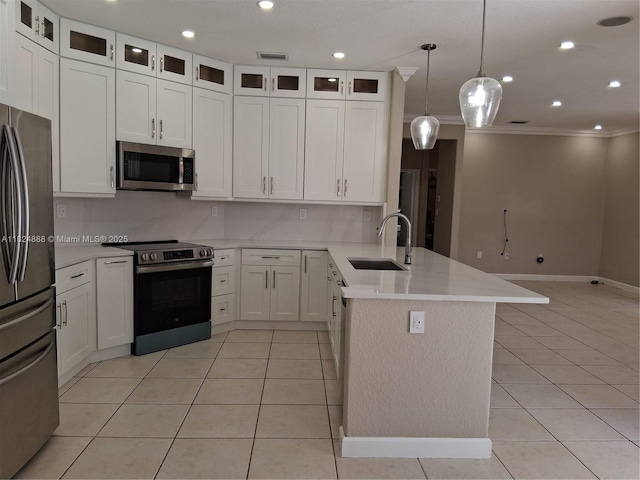 3610 SW 167th Ter, Miramar, FL 33027 - kitchen with appliances with stainless steel finishes, a peninsula, ornamental molding, light tile patterned floors, and light countertops