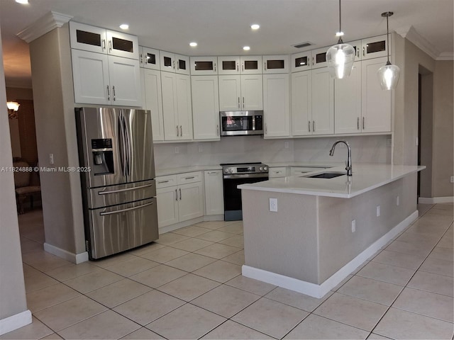 3610 SW 167th Ter, Miramar, FL 33027 - kitchen featuring appliances with stainless steel finishes, a peninsula, light countertops, white cabinets, and light tile patterned floors