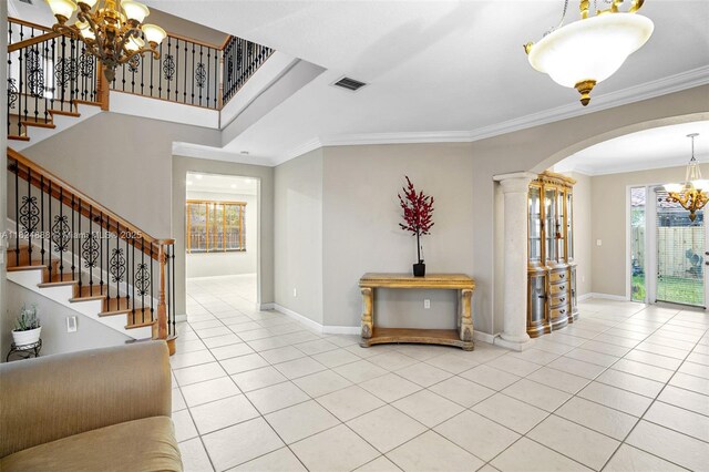 3610 SW 167th Ter, Miramar, FL 33027 - entryway featuring a chandelier, arched walkways, tile patterned flooring, crown molding, and healthy amount of natural light