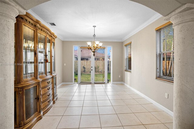 3610 SW 167th Ter, Miramar, FL 33027 - unfurnished dining area featuring a chandelier, crown molding, arched walkways, and light tile patterned flooring