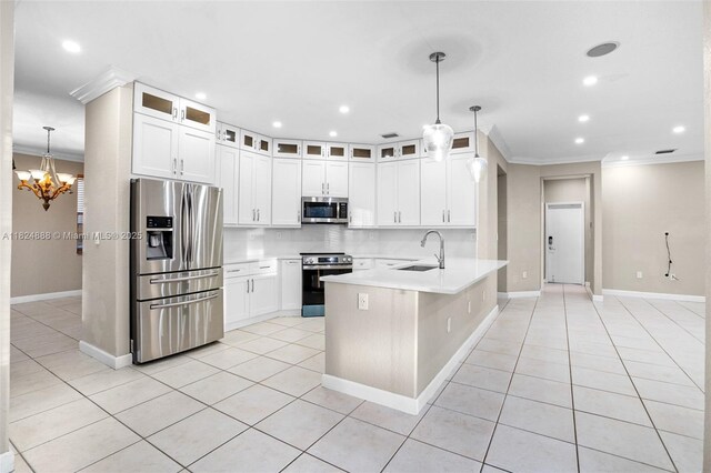 3610 SW 167th Ter, Miramar, FL 33027 - kitchen featuring appliances with stainless steel finishes, a peninsula, crown molding, light tile patterned floors, and a chandelier