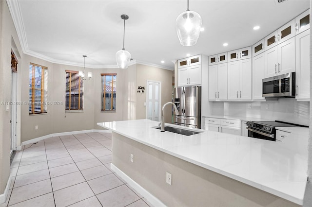 3610 SW 167th Ter, Miramar, FL 33027 - kitchen featuring stainless steel appliances, light tile patterned floors, crown molding, hanging light fixtures, and white cabinets