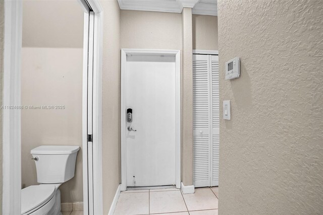 3610 SW 167th Ter, Miramar, FL 33027 - bathroom featuring tile patterned floors, a textured wall, a closet, and crown molding