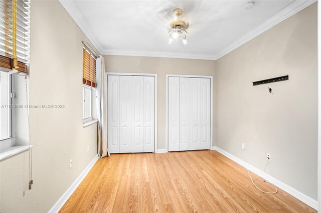 3610 SW 167th Ter, Miramar, FL 33027 - unfurnished bedroom featuring two closets, light wood-type flooring, crown molding, and multiple windows