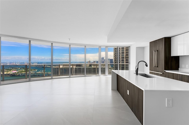 488 NE 18th St Unit 4112, Miami, FL 33132 - kitchen featuring modern cabinets, dark brown cabinetry, light countertops, and floor to ceiling windows