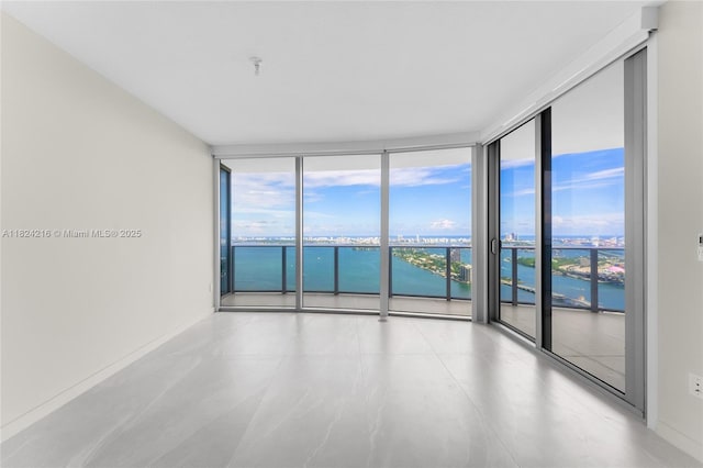 488 NE 18th St Unit 4112, Miami, FL 33132 - empty room with a wall of windows, a water view, and fire sprinkler in ceiling