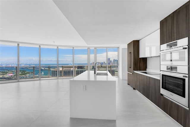 488 NE 18th St Unit 4112, Miami, FL 33132 - kitchen featuring modern cabinets, stainless steel double oven, expansive windows, and light countertops