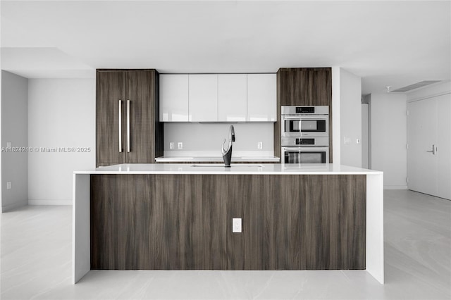 488 NE 18th St Unit 4112, Miami, FL 33132 - kitchen with stainless steel double oven, white cabinets, modern cabinets, and light countertops