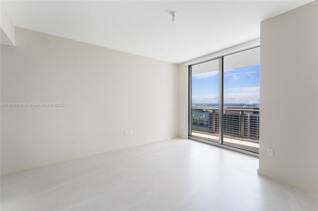 488 NE 18th St Unit 4112, Miami, FL 33132 - empty room with a wall of windows and fire sprinkler in ceiling