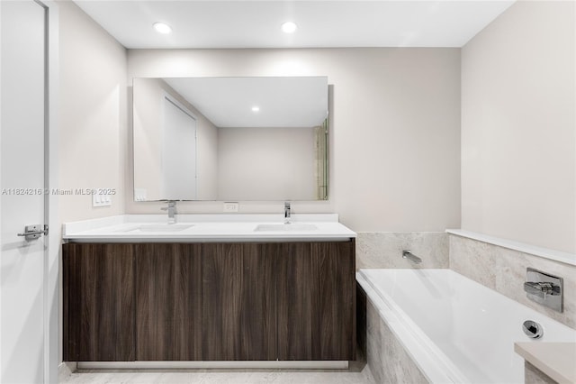 488 NE 18th St Unit 4112, Miami, FL 33132 - bathroom featuring double vanity, a garden tub, and recessed lighting