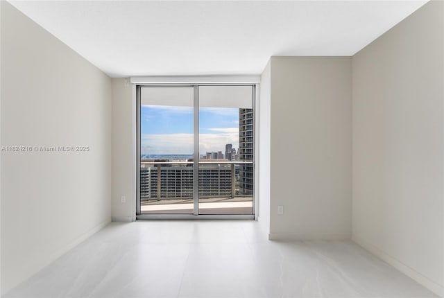 488 NE 18th St Unit 4112, Miami, FL 33132 - spare room featuring a wall of windows and a city view