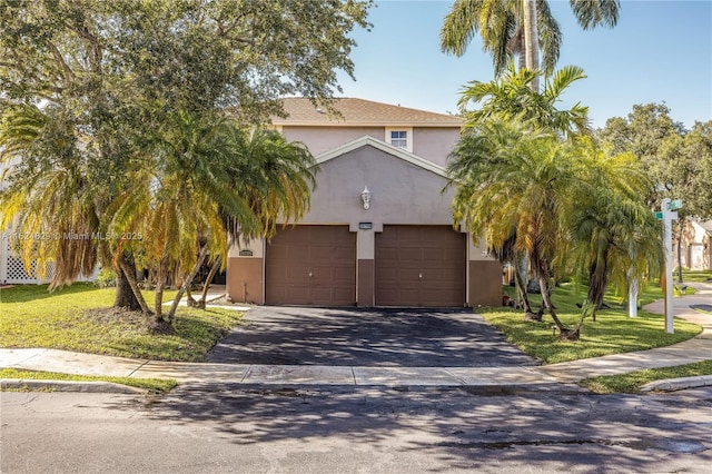 20709 NW 1st St, Pembroke Pines, FL 33029 - view of property hidden behind natural elements with stucco siding, a garage, and asphalt driveway