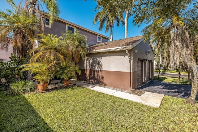 20709 NW 1st St, Pembroke Pines, FL 33029 - view of side of home featuring stucco siding, a lawn, and asphalt driveway