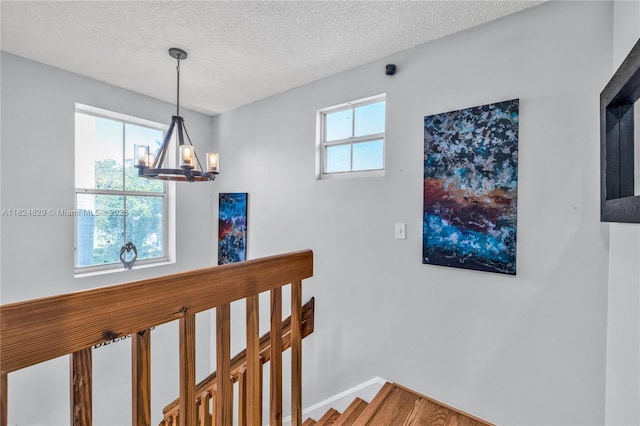 20709 NW 1st St, Pembroke Pines, FL 33029 - staircase featuring a textured ceiling, a chandelier, and wood finished floors