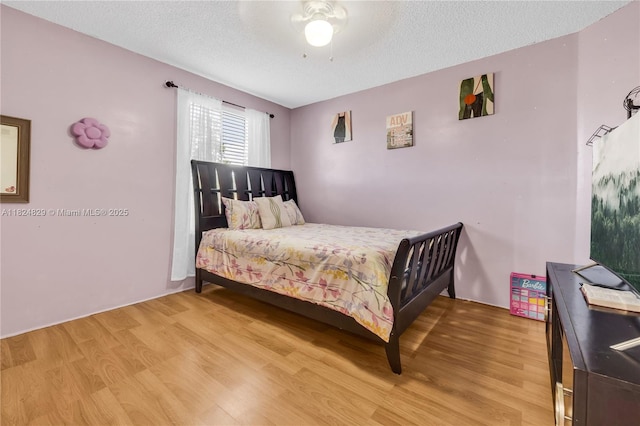 20709 NW 1st St, Pembroke Pines, FL 33029 - bedroom featuring light wood-style flooring, a textured ceiling, and a ceiling fan