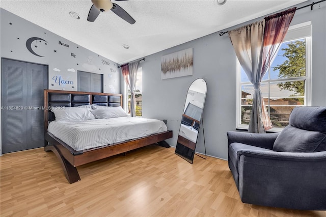 20709 NW 1st St, Pembroke Pines, FL 33029 - bedroom featuring lofted ceiling, a textured ceiling, light wood-style floors, and a ceiling fan