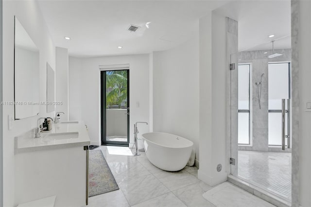 718 Valencia Ave Unit 204, Coral Gables, FL 33134 - full bathroom featuring a stall shower, a freestanding tub, double vanity, and marble finish flooring